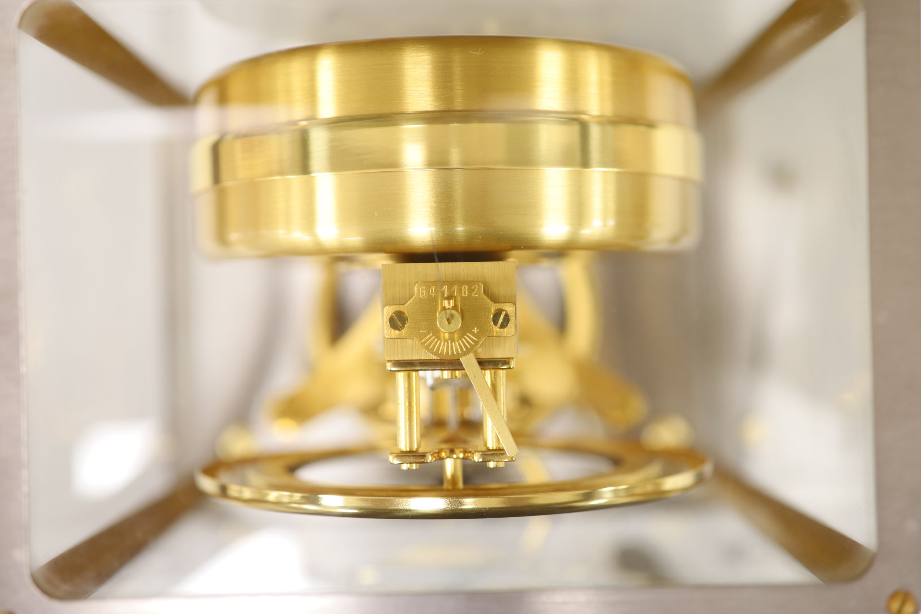 A Jaeger le Coultre Atmos mantel clock, in silvered and gilt metal glazed panelled case, height 23cm